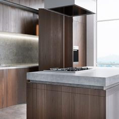 a modern kitchen with wood cabinets and white counter tops, along with an island in the middle