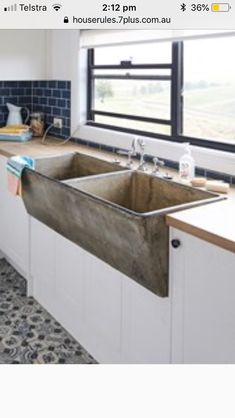 a kitchen with a sink, window and counter top in the middle of it's counters