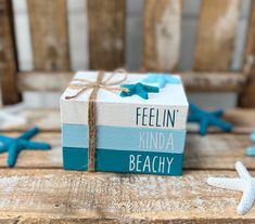 a wrapped present box with the words feelin'kinda beachy written on it