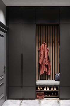 a coat and shoes are on the bench in front of an open closet with striped walls