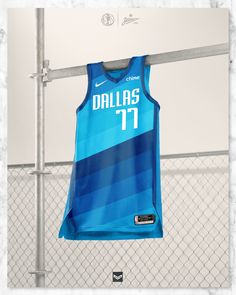 a basketball jersey hangs on a rack in front of a chain link fence with the word dallas 11 printed on it