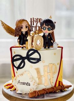 two figurines sitting on top of a cake with the number forty and an angel