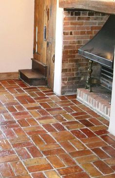 a brick floor with a fireplace in the corner