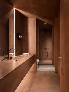 a bathroom with brown walls and flooring