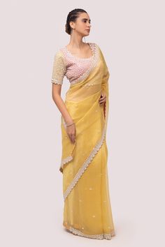 Mustard saree in organza base with sequins, stone and cutdhana embroidery. Paired with embroidered blouse.
Component: 2
Pattern: Embroidered
Type Of Work: Sequin, stone, cutdhana
Neckline: Round
Sleeve Type: Half
Fabric: Organza
Color: Yellow
Other Details: 
Back tassel tie-up
Occasion: Puja - Aza Fashions Yellow Georgette Saree, Designer Saree Blouse, Reception Saree, Reception Lehenga, Georgette Saree, Organza Saree, Traditional Sarees, Orange Fashion, Thread Work