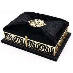 a black and gold box with a monogram on it