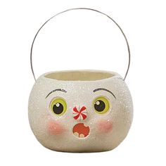 a small white vase with a face painted on it's side and eyes open