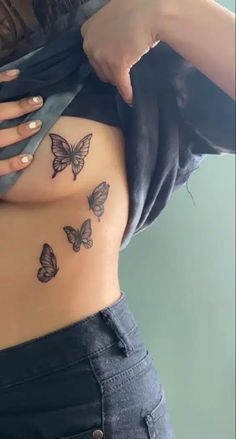 a woman with butterfly tattoos on her stomach