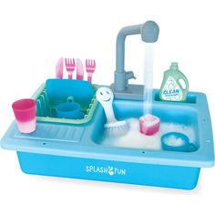 a toy sink with toothbrushes, soap and other bathroom items in the sink