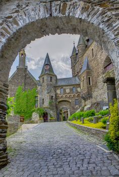 an archway leading to a castle like building