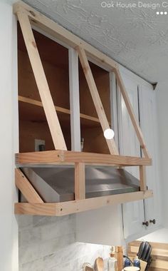 an unfinished kitchen window is being installed in the wall above the stovetop and cabinets