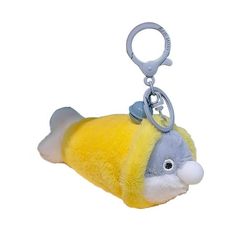 a yellow and gray stuffed animal keychain with a fish on it's side