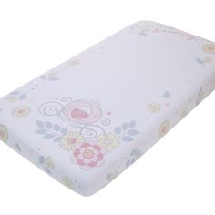 a close up of a baby crib mattress with flowers on it's cover