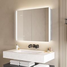 a bathroom with a sink, mirror and towel rack in it's center area