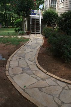 a stone walkway leading to a house