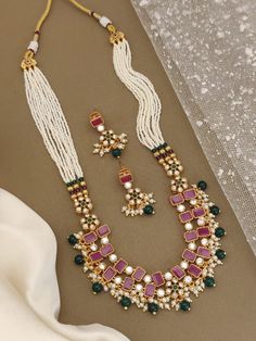 Your jewelry collection with this exquisite Heer Rajwadi Meenakari necklace and Maharashtrian earrings set, featuring stunning green and pink stones. Handcrafted with precision and attention to detail, this set is perfect for adding a touch of elegance to any outfit. The combination of pearl beads and colorful stones creates a unique and eye-catching look that is sure to turn heads. Ideal for special occasions or everyday wear, this set is a must-have for any jewelry lover. Style & Look: Elevate your style and look with our exquisite Heer Rajwadi Meenakari necklace and Maharashtrian earrings set. Handcrafted with meticulous attention to detail, this stunning jewelry set features vibrant green and pink stones paired with lustrous pearl beads, creating a captivating and unique design. The in Pink Meenakari Temple Necklace Gift, Pink Kundan Temple Necklace With Meenakari, Pink Meenakari Kundan Temple Necklace, Traditional Green Pearl Necklace With Meenakari, Bollywood Festive Necklaces With Matching Earrings, Pink Meenakari Temple Jewelry Sets, Pink Meenakari Jewelry For Eid, Pink Cutdana Temple Jewelry Necklace, Traditional Pink Pearl Necklace For Celebration