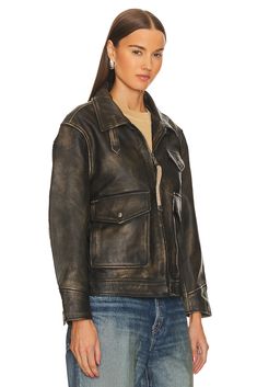 Self: 100% genuine leather, Lining: 100% polyester.  Made in Pakistan.  Professional leather clean only.  Front zipper closure.  Breast pocket and side button pockets.  D-ring and strap detail at front with button cuffs.  Leather fabric with adjustable strap at back.  .  .  .  .  .  .  .  .  . Fall Leather Biker Jacket With Multiple Pockets, Leather Biker Jacket With Multiple Pockets For Fall, Utility Leather Jacket With Pockets, Chic Leather Biker Jacket With Button Closure, Leather Long Sleeve Outerwear With Multiple Pockets, Rugged Leather Jacket With Button Closure, Rugged Leather Jacket With Zipper Closure, Brown Leather Outerwear With Zipper Closure, Rugged Leather Outerwear With Zipper Closure