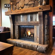 the fireplace is made from wood and has a fire place with logs on top of it