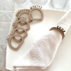 napkins and wine glasses sitting on top of a white plate