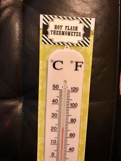 a thermometer sitting on top of a black leather chair