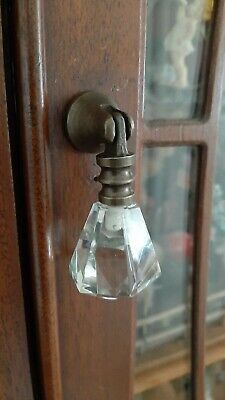 an antique door handle with clear glass knobs