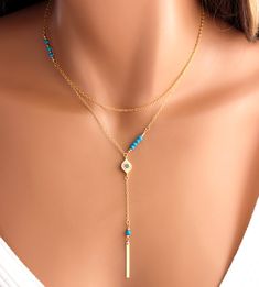 "This is a 925 sterling silver, multi strand Evil Eye Lariat Y style necklace! Genuine turquoise gemstones 3-4mm make this double strand necklace stunning! Necklace has a shorter choker length chain and a longer Y style chain with an evil eye center pendant with small pave blue crystals. A 1\" sterling silver bar pendant with a turquoise gemstone hangs from drop. Drop measures 3\" with bar pendant.ds This is stunning statement piece, makes a great gift for that unique lady! Comes nicely boxed, f Adjustable Blue Jewelry With Delicate Chain, Elegant Adjustable Blue Layered Necklace, Elegant Blue Adjustable Layered Necklace, Blue Adjustable Layered Necklace As Gift, Adjustable Blue Layered Necklace As Gift, Adjustable Blue Layered Necklace Gift, Elegant Turquoise Jewelry For Layering, Blue Adjustable Clavicle Chain Jewelry, Adjustable Blue Collar Necklace