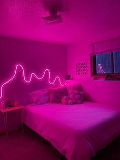 a bed with pink lights in a room