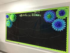 a bulletin board with flowers on it in a classroom setting at the end of school