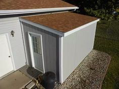 an overhead view of a small shed with a door and windows on the side of it