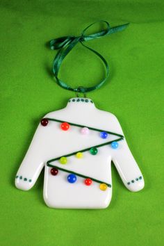 a white ceramic ornament with christmas lights on it