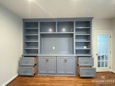 an empty room with blue cabinets and drawers