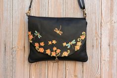 "► Our FREE delivery is TRACKED, secure and super FAST! Please provide a PHONE number for DHL express delivery. This dragonfly leather crossbody women's leather handbag is entirely hand-made with the best quality Spanish cowhide leather. The bag is handpainted with a colorful nature-inspired design in orange, turquoise, and other vibrant colors and decorated with a brass pendant of a dragonfly. This women's purse is very lightweight and feels soft and smooth. We design and hand paint our product Handmade Black Satchel As Gift, Handmade Artisan Leather Bag, Artisan Handmade Leather Bag, Artisan Soft Leather Bag For Gift, Artisan Black Bag As Gift, Hand-stitched Crossbody Shoulder Bag For Gift, Hand-stitched Crossbody Shoulder Bag As Gift, Hand-stitched Leather Shoulder Bag Gift, Artisan Handmade Satchel For Everyday