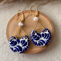 We combine art and elegance to create this beautiful piece. Our handmade earrings will be the perfect element to make your outfit standout. You could have the entire collection or gift them to someone special.  Material: Real Gold plate brass, Talavera, genuine peals.  Dimensions: Drop Length 6cm, width 3cm Features : Lightweight, Unique and Simple design The Talavera of Puebla is part of the intangible heritage of humanity, declared by UNESCO. It is a type of majolica ceramic with a mixture of Artisan Handmade Blue Earrings, Handmade Artisan Blue Earrings, Blue Brass Dangle Earrings, Artisan Blue Earrings, Artisan Blue Brass Earrings, Handmade Artistic Blue Earrings, Traditional Blue Brass Earrings, Artistic Blue Round Earrings, Artisan Blue Earrings With Artistic Design