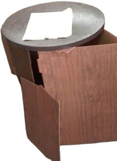 a wooden table with a paper holder on it's side and a piece of paper sticking out of the top