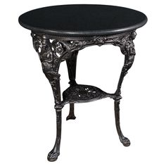 an ornate table with black marble top