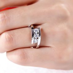 a woman's hand with a diamond ring on it