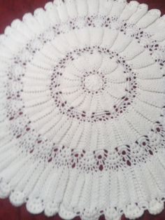 a crocheted doily is shown on a table