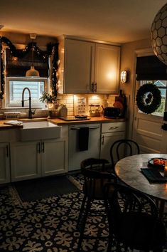 the kitchen is decorated for christmas with wreaths and lights