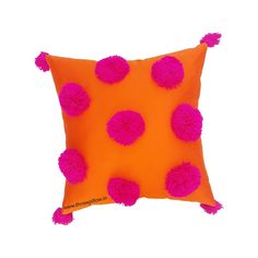 an orange pillow with pink pom - poms on it