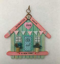 a house shaped ornament hanging on the wall