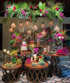 an arrangement of flowers and candles are on display at a wedding reception in a tropical setting