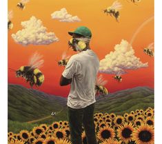 a man standing in front of a field of sunflowers with bees flying around