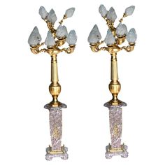 a pair of gold and crystal candlesticks with white frosted crystals on them