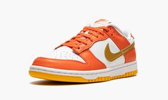 The Women’s Nike Dunk Low “Golden Orange” is a women’s-exclusive version of the retro basketball shoe in a colorway based on an original option from 1985.  The shoe in question is the “Syracuse” Dunk High, a white and orange colorway from the college basketball-inspired “Be True to Your School” collection.  Like the “Syracuse,” the “Golden Orange” features a white leather base with contrasting orange leather overlays.  Unlike the “Syracuse,” the “Golden Orange” dons a Golden Orange-colored leath Womens Dunk Low, Wmns Dunk Low, Retro Basketball Shoes, Retro Basketball, School Collection, Orange Shoes, Dunk High, White And Orange, Casual Sneakers Women