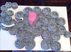 an elephant made out of cupcakes sitting on top of a table