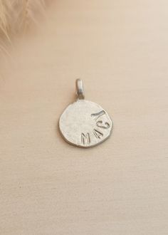 This personalized circle charm is the perfect addition to any charm bracelet or necklace. Made with a round shape, it can be customized with a name or initials, making it a unique and sentimental piece. Crafted with high-quality materials, it is sure to become a cherished accessory for years to come. Size: 18mm Available in sterling silver, gold plated over sterling silver, and rose gold plated over sterling silver. We can fit up to 8 characters (including spaces). Minimalist Round Charms For Gifts, Sterling Silver Charms Round Pendant For Gifts, Nickel Free Medallion Charms For Gifts, Everyday Engraved Charm Necklace With Round Pendant, Handmade Round Pendant Charms For Gifts, Minimalist Everyday Round Charms, Everyday Round Minimalist Charms, Personalized Medallion Charms For Gifts, Personalized Circular Jewelry