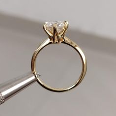 a close up of a ring with a diamond on it