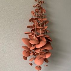 a bunch of clay hearts hanging on a wall