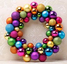 a colorful christmas ornament wreath with ornaments