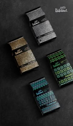 four different types of business cards on a black surface with green and blue designs in the middle